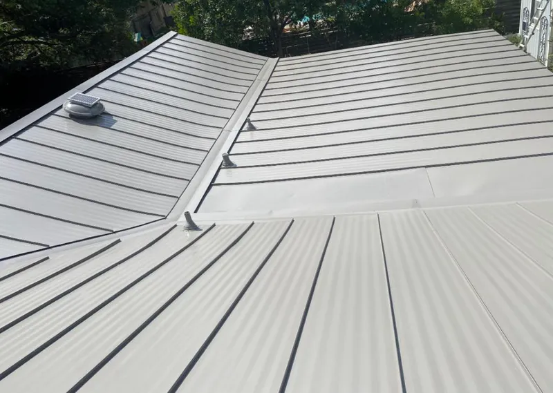 Solar attic fan installed on a metal roof for Roof Ventilation in Bethalto